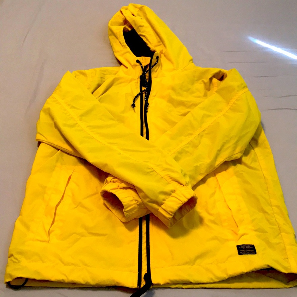 Yellow waterproof jacket for men by H&M. Perfect for walking on a rainy day.